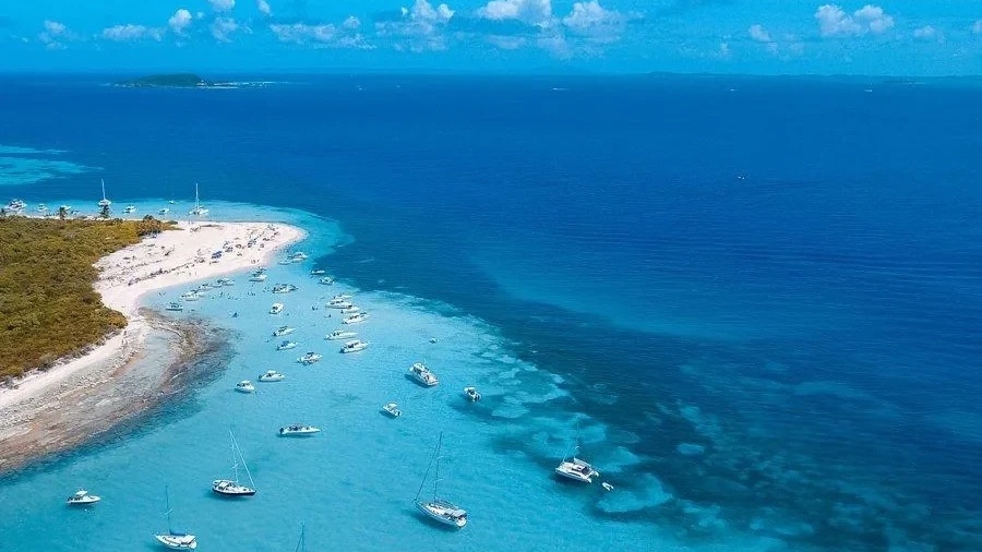 Aerial view of Las Picuas Beach with sailboats anchored in turquoise water